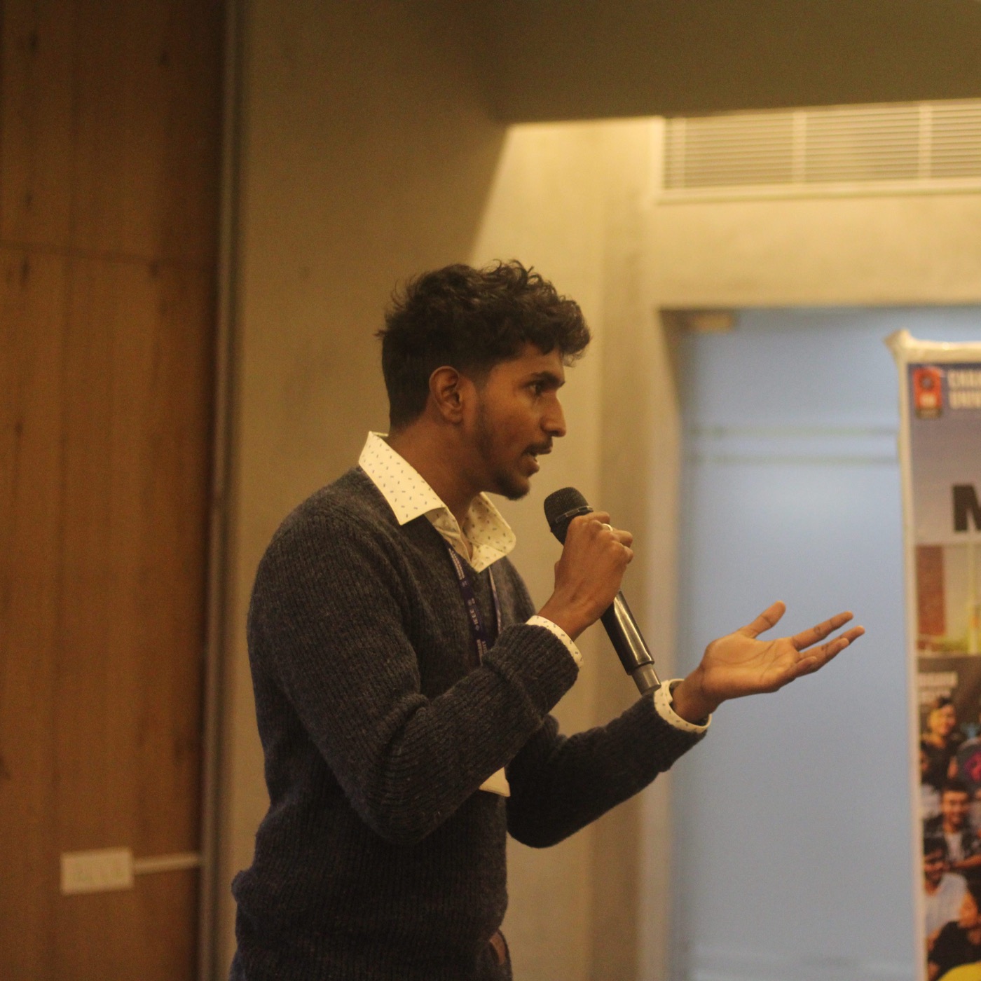 Jayanth Koppala addressing attendees with a microphone at an IEEE Chandigarh University event.